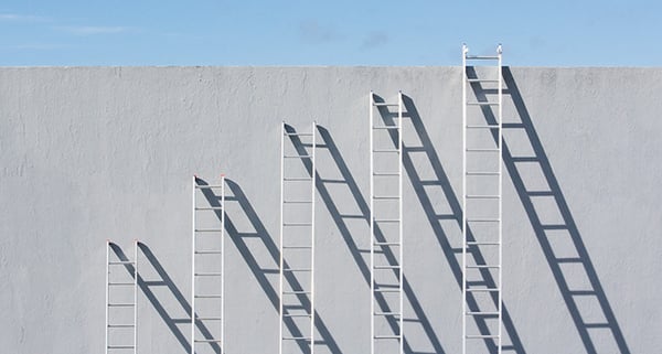 Ladders leaning up against a wall